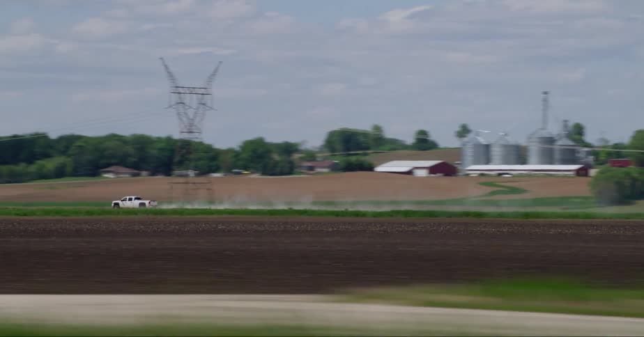A truck speeds past the power plant