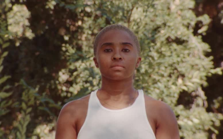 Young woman wearing a white sweatshirt caught on vintage film
