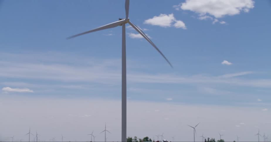 A wind farm in a flat landscape during the daytime
