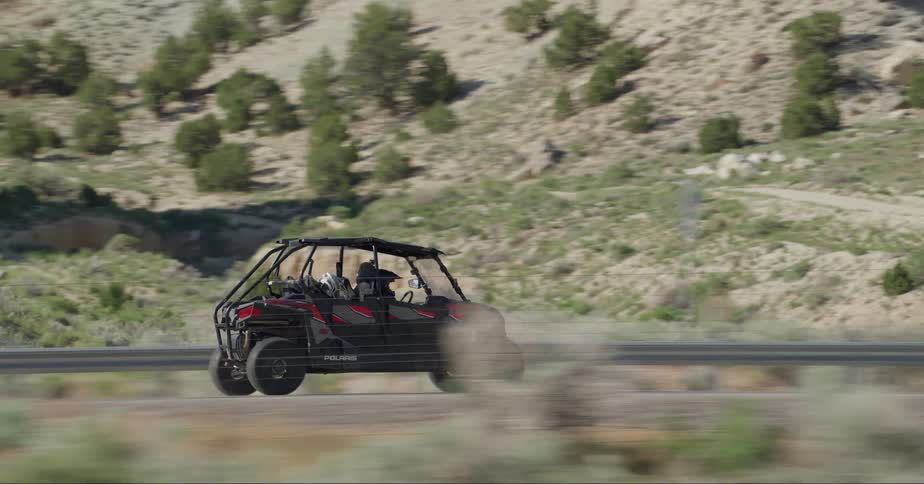 Person driving a small compact car on a nature trip
