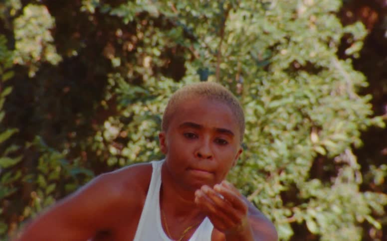 Female dancer dances slowly near trees