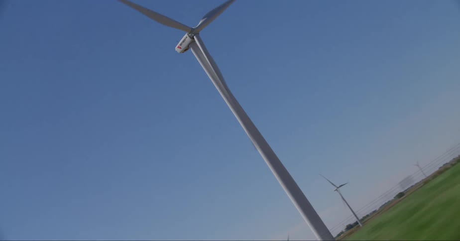 Windmills on a big field at midday