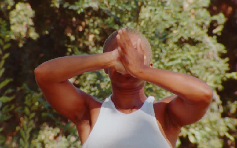 Portrait of a woman gesturing with her hands in yoga positions