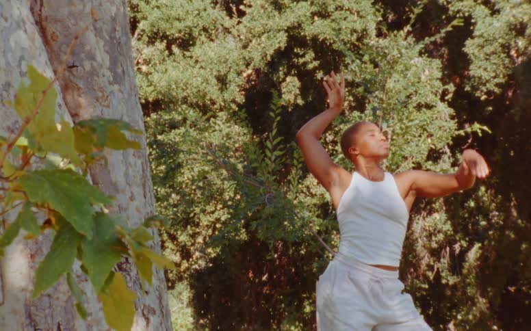 A woman is dancing in the forest
