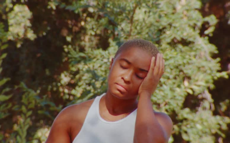 Female dancer dances outdoors among the trees