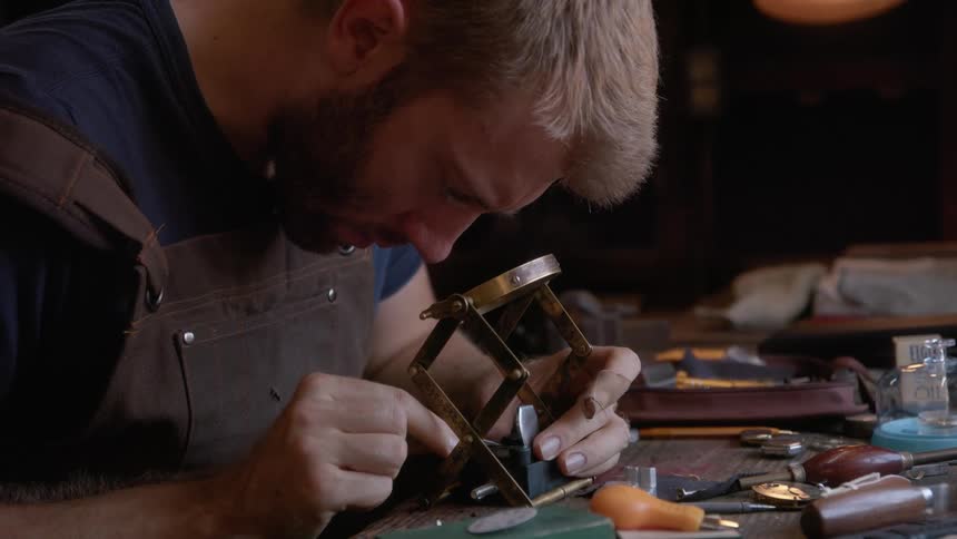 Craftsman working on a delicate piece over the workbench