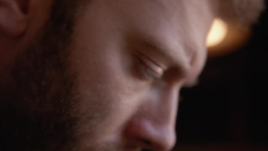 Craftsman thinks briefly before continuing his work