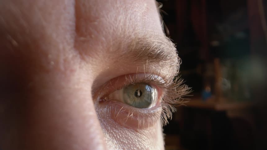 The mans hazel eye is twitching