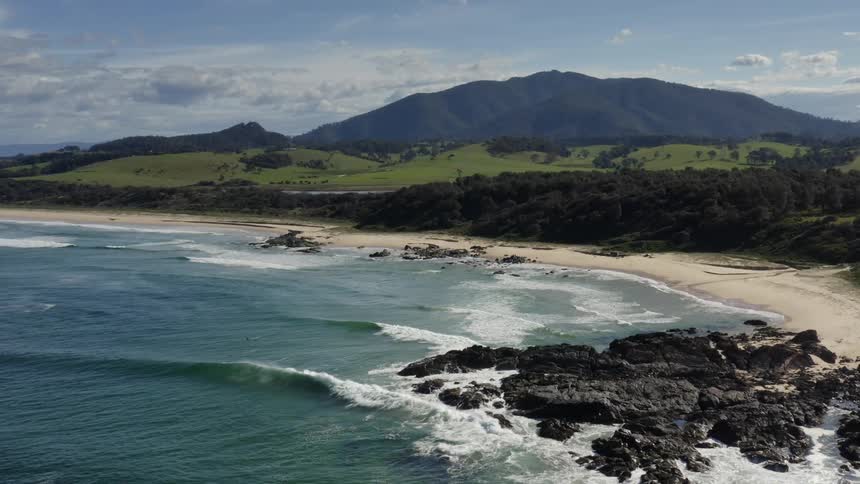 Aerial of a paradisiacal beach with rocks on the coast