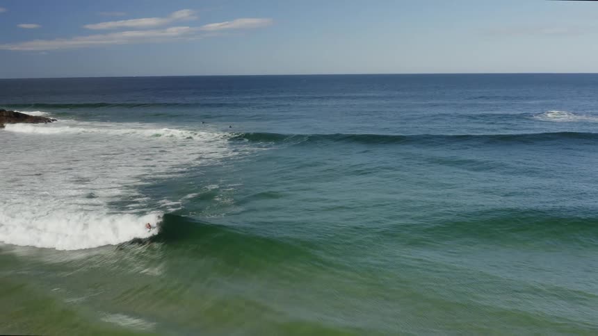 Person boogie boards in ocean