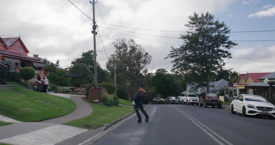 A young man rollerblading down an urban street