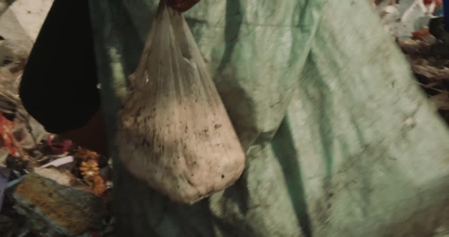 Person walks through trash pile