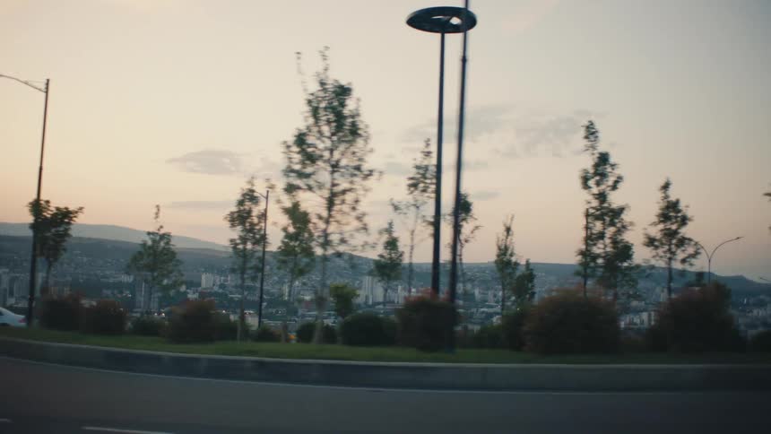 A view of an urban city with a chain of mountains on the horizon