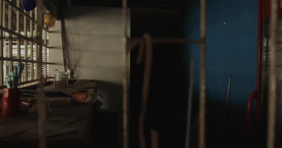Tools and materials sit on workbench in open air workshop