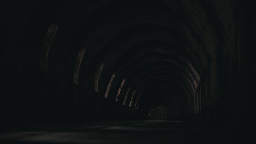 Inside a dark tunnel with small windows