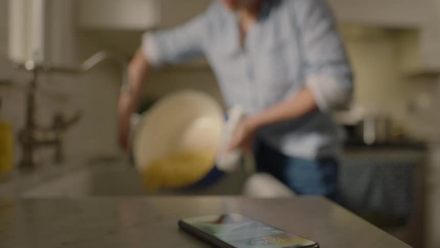A person filtering grain in the kitchen