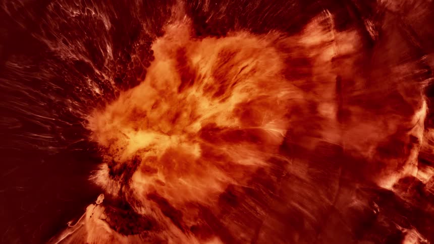 A red to orange liquid is expanding due to an explosion