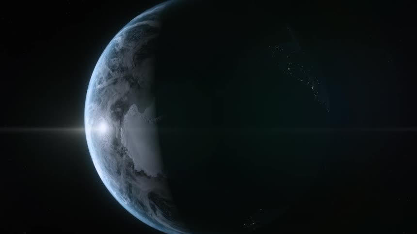 Planet earth rotating in space and the sun shining on the left side
