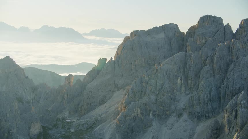 Huge rocky mountains above the clouds