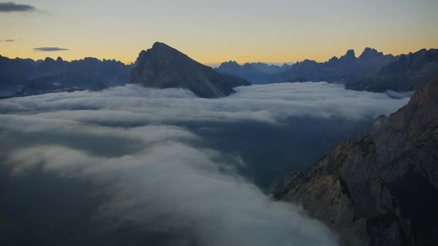 Aerial a mountain covered in clouds during dawn