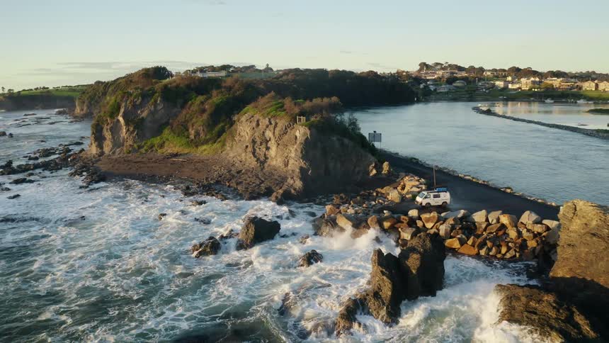Aerial of sea waves hitting the beach shore