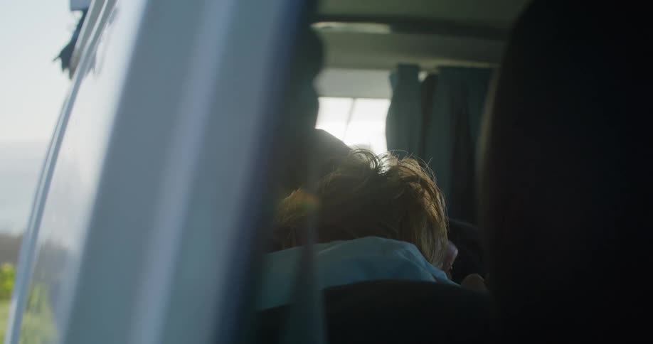 A person resting in a car