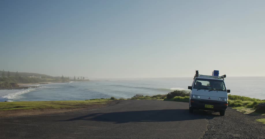 A van is parked by the shore