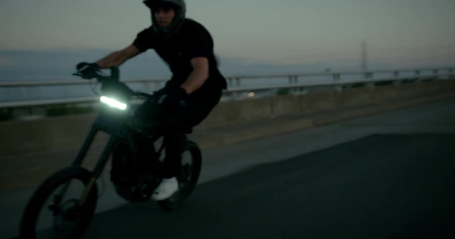 A man riding a motorcycle at high speed