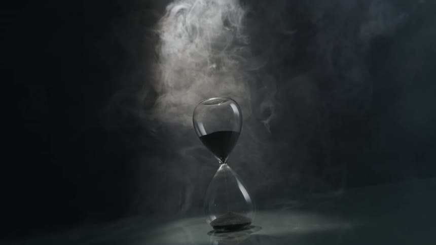 Landscape of a running sand timer placed on the ground