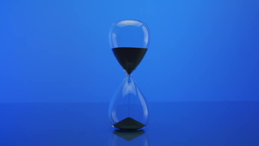 An hourglass with its grains of sand falling