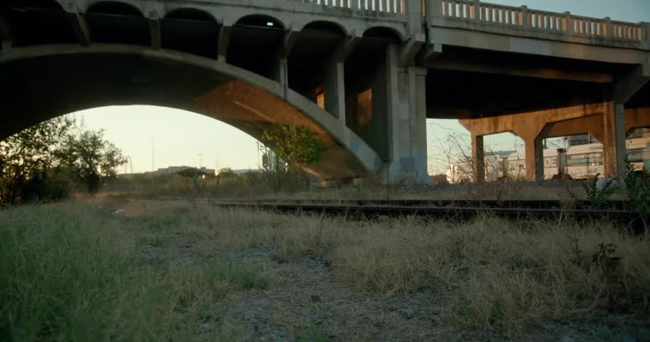 A man speeding on a motorcycle alongside a train