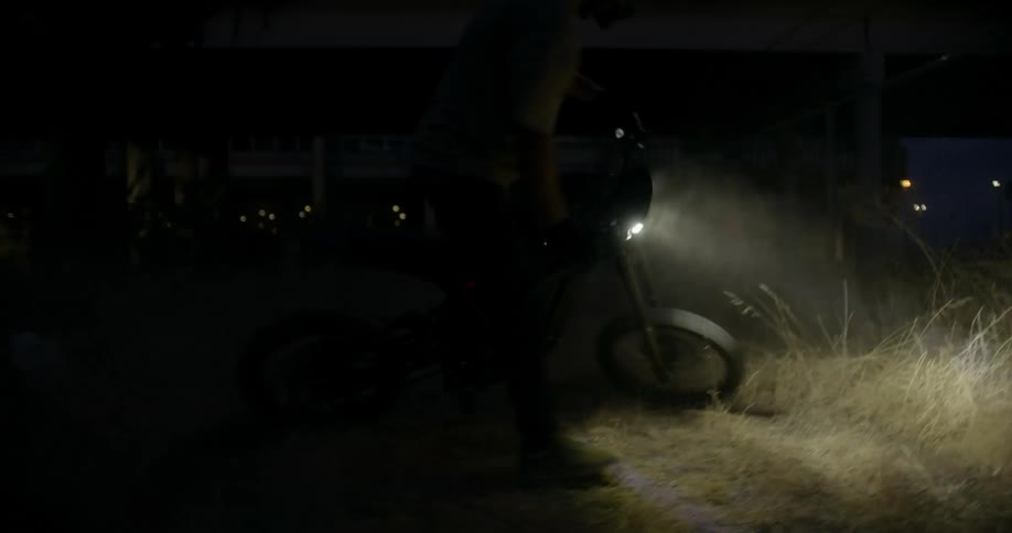 A person performing a maneuver by turning the motorcycle at an angle that makes a complete turn