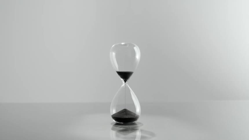 The sand pours through the hourglass