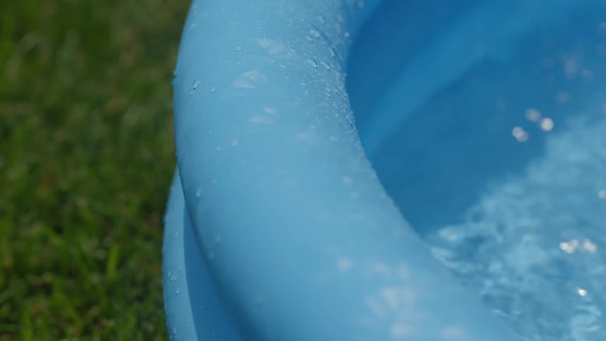 Edge of a blue plastic swimming pool