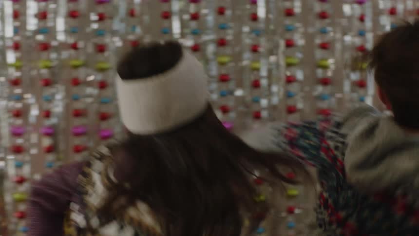 People dancing while a woman records and everyone is smiling and happy