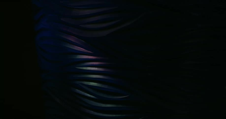 An object with several sharp lines being illuminated by a passing beam of light