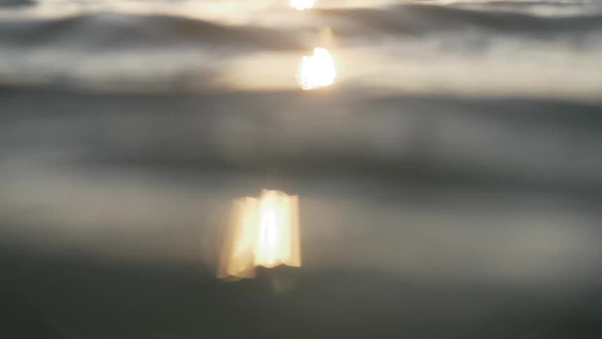 Sea with gentle waves with sunlight reflecting on the water