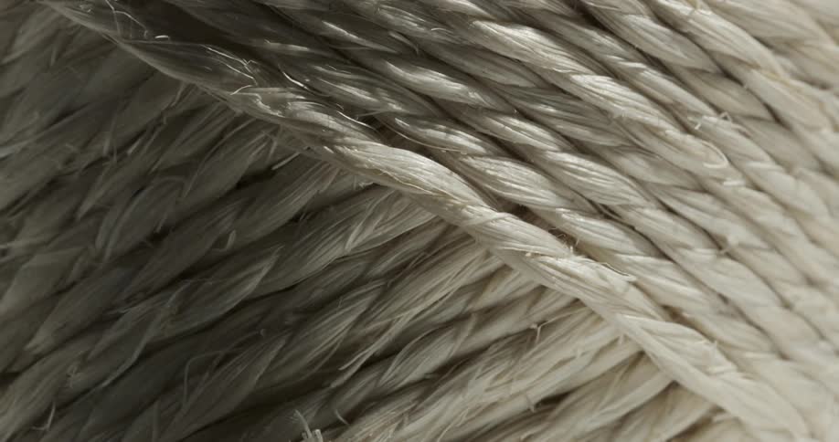 Lights and shadow over a roll of white rope