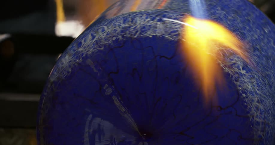 A blue ceramic vase being heated