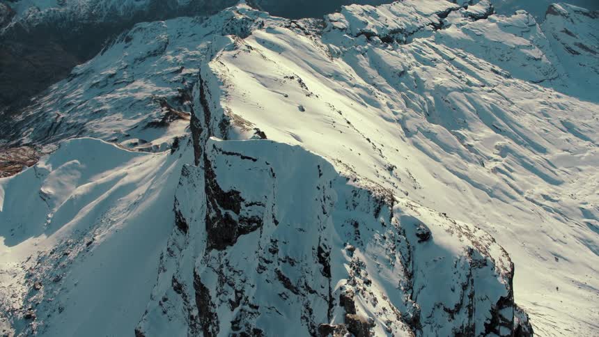 Aerial view of snow covering the slopes and ridges of a mountain