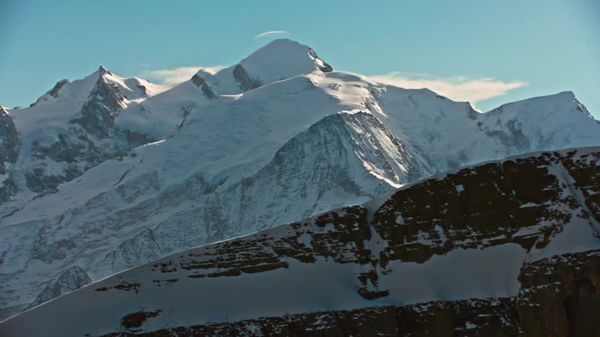 A drone captures a snow covered mountain range