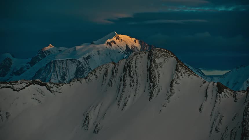 Heavy clouds are over the snowy mountains