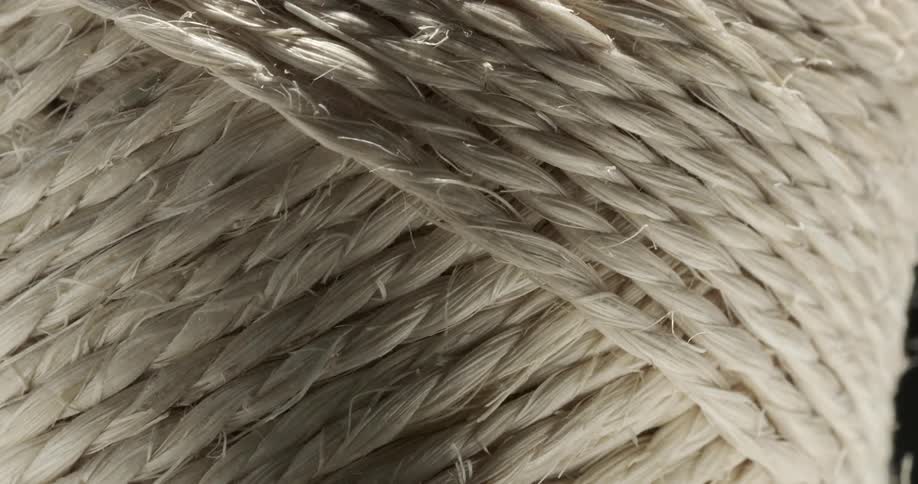 Close up of a roll of white rope under moving lights