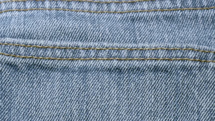 Yellow stitching on blue jean material