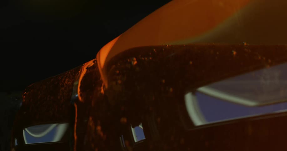 Reflective molten glass containing bubbles turns on post during glass making
