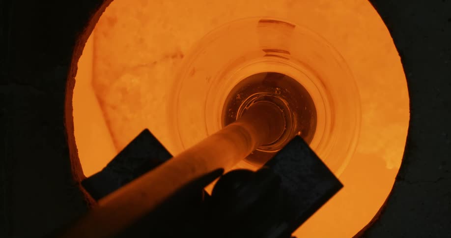 Manufacturing and production work of a glass vase in a furnace