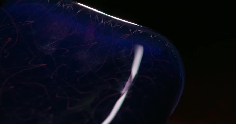 Light being passed over an abstract blue crystal glass vase
