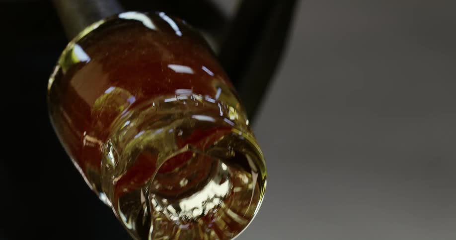 Hot glass object being rolled from side to side in the cooling process