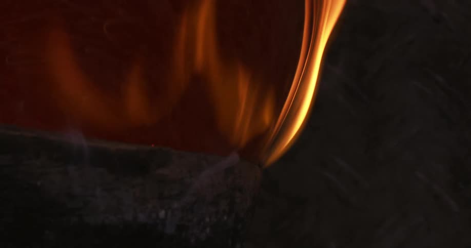 An iron passing through an object that is rotating causes it to catch fire