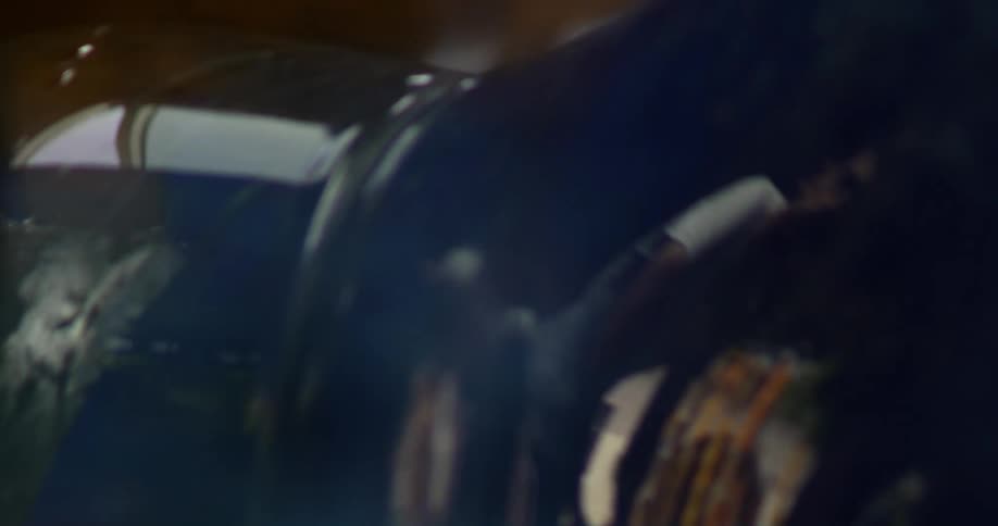 A closeup of a blue vase in production with fire being applied